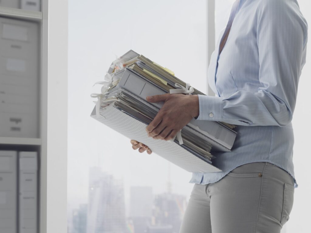 Office worker carrying paperwork in the office